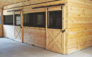 horse stalls inside large horse barn